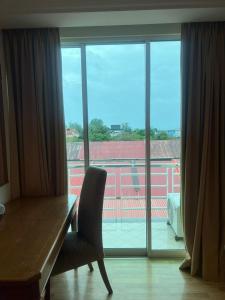 a room with a desk and a large glass window at Kudat Ria Hotel Plt in Kudat