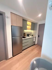 a kitchen with a stainless steel refrigerator at Adamant Grand in Laurel de Lagunillas