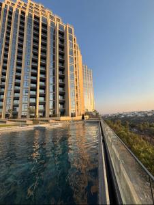 a view of two tall buildings from a swimming pool at Adamant Grand in Laurel de Lagunillas