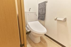 a bathroom with a white toilet in a room at Green hills 102 in Kumamoto