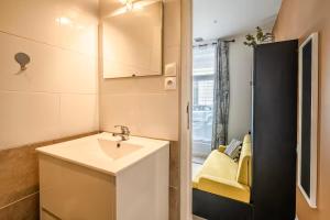 a small bathroom with a sink and a mirror at Studio narbonne in Narbonne
