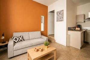 a living room with a couch and a table at Studio narbonne in Narbonne