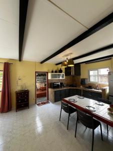 a kitchen with a table and chairs in a room at La Caze Vital in Saint-Joseph