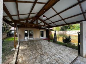 an outdoor patio with awning and a fence at La Caze Vital in Saint-Joseph