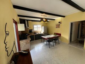 a kitchen and dining room with a table and chairs at La Caze Vital in Saint-Joseph