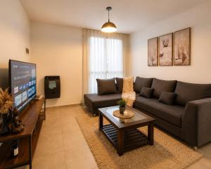 a living room with a couch and a tv at Bohemian dream in Ezeiza