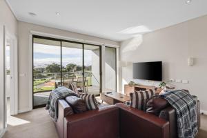 a living room with two couches and a tv at Potters Hill Haven in San Remo