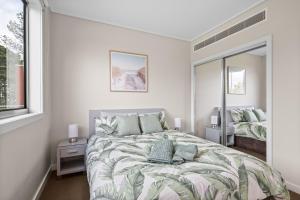 a bedroom with a large bed and a window at Potters Hill Haven in San Remo +20 photos