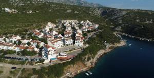 an aerial view of a town on a hill with water at Apartment Vila ** in Stinica