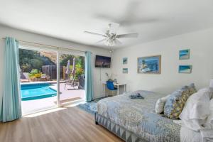 a bedroom with a bed and a swimming pool at NEW Relax & Explore from MissionViejo | Pool | Spa in Mission Viejo