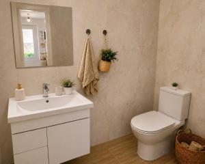 a bathroom with a white toilet and a sink at Mikel's Village House in Káto Garoúna