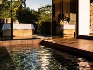 a house with a swimming pool next to a bedroom at Boutique Amazonia Hotel Restaurante in Alter do Chao
