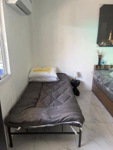 a bed sitting in the corner of a room at SET Inn-2 in Kata Beach