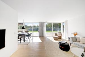 a living room with a couch and a table at Holiday Home On Bornholm Close To Sea And Beach in Vester Sømarken