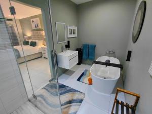 a bathroom with a toilet and a bedroom at Underwood Country Manor in Underberg +85 photos