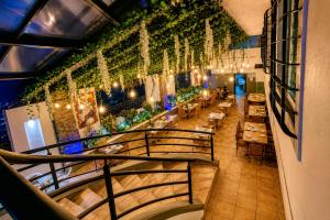a staircase in a restaurant with tables and chairs at Hotel Borda Cuernavaca in Cuernavaca
