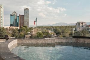 a swimming pool with a view of a city at Kimpton El Castelar Polanco by IHG in Mexico City