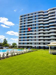 a large building with a red kite in the air at Pool View Apartment Varna in Varna City