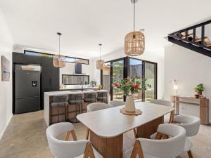 a kitchen and dining room with a table and chairs at Stone River Villa 2 - Private Escape - Heated Pool in Margaret River Town