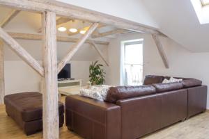 a living room with a leather couch and a table at Villa Cujez with Pool & Sauna - Happy Rentals in Rečica ob Savinji