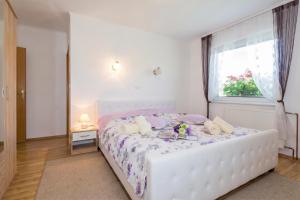 a white bed in a room with a window at Villa Cujez with Pool & Sauna - Happy Rentals in Rečica ob Savinji +17 photos