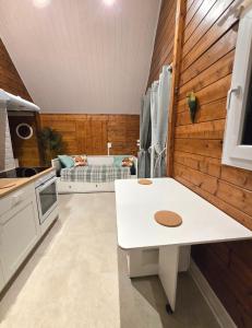 a kitchen with a white table in a room at Le Chalet Spa Piscine in Rimbach-près-Masevaux
