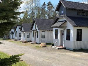 a row of houses on a street at The Evergreen | Walk to Rangeley Lake, Sled & ATV Access in Rangeley