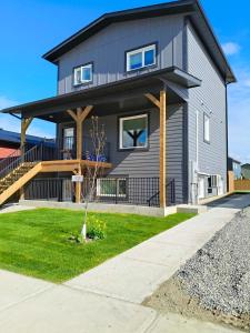 a gray house with a black roof at Private 1BR Suite with Kitchen, Laundry, Parking & 1 Gigabit Internet in Whitehorse