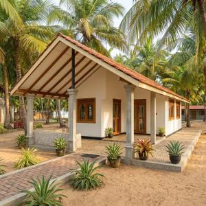 a small house with a roof at Salty Mango Resort in Kalpitiya