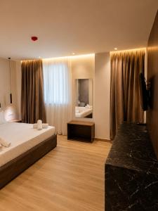 a hotel room with a bed and a window at Bedo Boutique Hotel in Golem