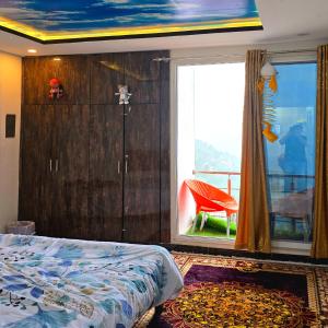 a bedroom with a bed and a window with a chair at Bhurban Nights - Glass Bed Murree Hills View - Lift - 15 Minutes from Murree & Mallroad in Murree