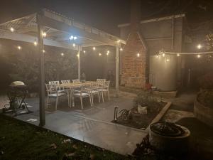 a patio at night with a table and chairs at Finney Cottage in Stanthorpe
