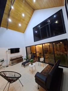 a living room with a couch and a tv at Villa Doña Isabel in Lunahuaná
