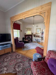 a living room with a couch and a tv at Finney Cottage in Stanthorpe