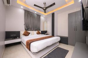 a bedroom with a large bed and a television at Hotel Maharani Palace in Varanasi