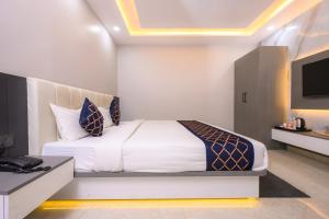 a bedroom with a bed and a television in it at Hotel Maharani Palace in Varanasi