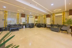 a lobby with couches and chairs in a building at Hotel Maharani Palace in Varanasi