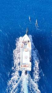 a boat in the middle of the blue water at HB'S iSLAND LiFE in Mathiveri