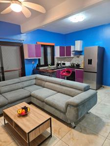 a living room with a couch and a kitchen at Hot Payton in Mamoudzou