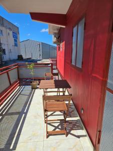 a wooden table and chairs on a balcony at Hot Payton in Mamoudzou