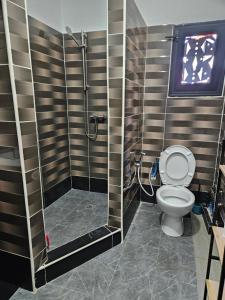 a bathroom with a shower and a toilet at Hot Payton in Mamoudzou +8 photos