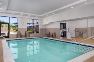 a pool with blue water in a hotel room at Hampton Inn Baltimore Bayview Campus in Baltimore