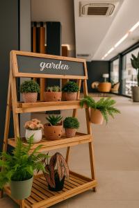 a shelf with potted plants on it in an office at Houi Hotel in Jodoh +11 photos