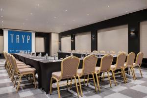 a conference room with a long table and chairs at Tryp By Wyndham Istanbul Sancaktepe in Istanbul +165 photos