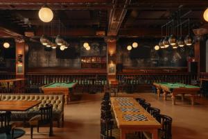 a restaurant with ping pong tables in the middle at Chicago Athletic Association, part of Hyatt in Chicago