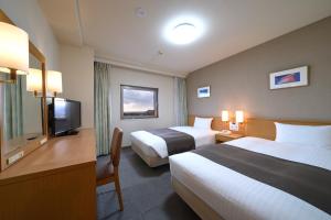 a hotel room with two beds and a flat screen tv at Hotel Hokke Club Hakodate in Hakodate +31 photos