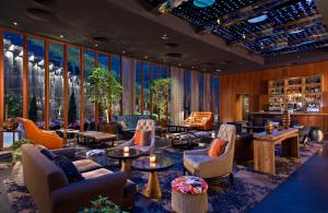 a lobby with couches and chairs and a bar at Dream Downtown, by Hyatt in New York
