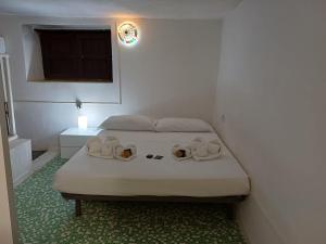 a bedroom with a bed with shoes on it at Il Casale Apartament&Rooms in Burgio