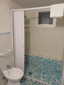 a bathroom with a sink and a toilet and a window at Il Casale Apartament&Rooms in Burgio +43 photos