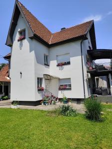 a white house with a red roof at Kuća JEKA in Vrnjačka Banja